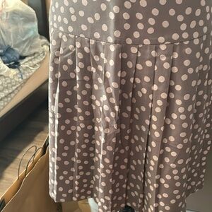 Pleated mini lined skirt . Polyester side zip .. fabric has a silkish look